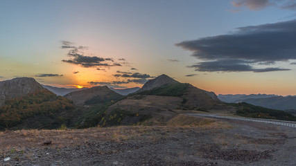 Fantastic sunset with the sun setting between the mountains in the area of Gordon, Leon (Spain)