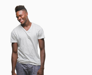 Young african american man over isolated background looking away to side with smile on face, natural expression. Laughing confident.