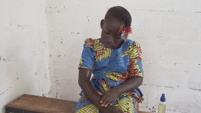 Prevention against malaria and dengue fever: little child protects with spray. 4K RAW clip, please modify and edit (color grade, stabilize, etc.) in postproduction.