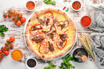 Pizza with Veal and Mozzarella. Beef, tomatoes, pasta pomidorro. Italian traditional dish. On the old background. Top view. Free space for your text.