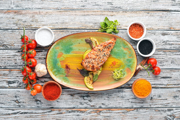 Baked chicken fillet with sesame and zucchini. On the old background. Free copy space. Top view.