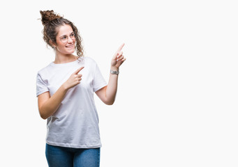 Beautiful young brunette curly hair girl wearing glasses over isolated background smiling and looking at the camera pointing with two hands and fingers to the side.