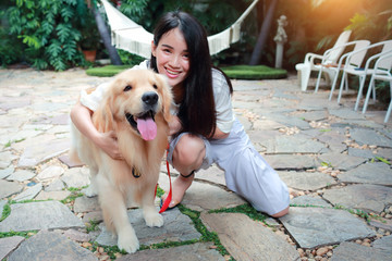 young and cute asian women playing with dog during holiday