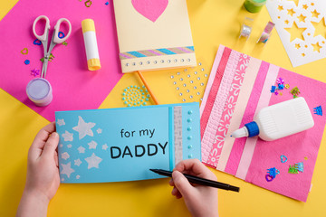 Girl signs a card