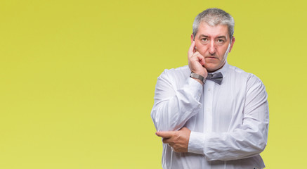 Handsome senior man wearing bow tie over isolated background thinking looking tired and bored with depression problems with crossed arms.