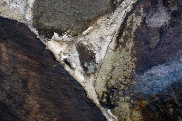 Close up of stone wall texture, with vibrant colors for creativity, imaginative backgrounds and ideas. Suitable for print, web, postcards, posters, flyers.