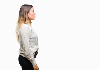 Young beautiful woman casual white sweater over isolated background looking to side, relax profile pose with natural face with confident smile.