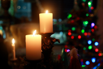 image of candle in the dark light with bokeh (christmas party concept)