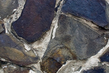 Close up of stone wall texture, with vibrant colors for creativity, imaginative backgrounds and ideas. Suitable for print, web, postcards, posters, flyers.