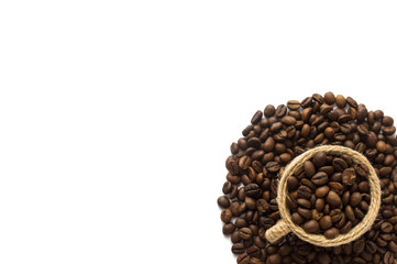Coffee beans and a cup at border of image with copy space for text. Coffee background or texture concept. Coffee beans on white background.