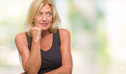 Middle age blonde woman over isolated background looking stressed and nervous with hands on mouth biting nails. Anxiety problem.