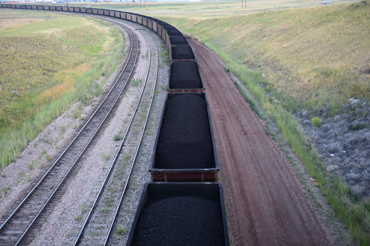 View Above A Long Winding Coal Train Transporting Coal From An Open Pit Mine, Powder River Basin, Wyoming