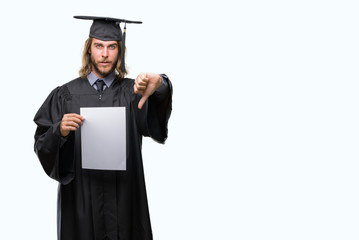 Young handsome graduate man with long hair holding blank paper over isolated background with angry face, negative sign showing dislike with thumbs down, rejection concept