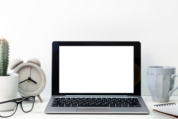 Obraz na płótnie Canvas Desk with mockup laptop, gray mug, cactus, concrete clock and glasses