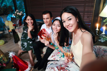 Happy group of friends celebrating new year party and do self portrait