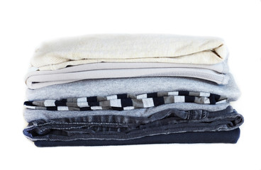 Stack gray winter clothes isolated on white background.