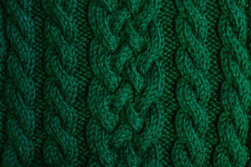 Texture of warm green knitted winter clothes.