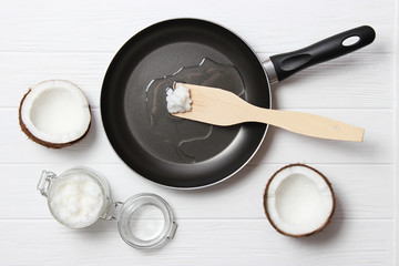Frying pan and coconut oil on a wooden table. Top view. fry in coconut oil.