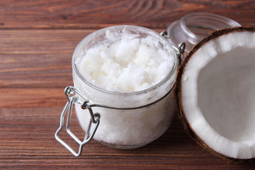 coconuts and coconut oil on a wooden background.