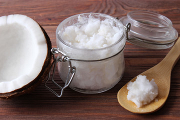 coconuts and coconut oil on a wooden background.