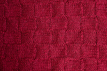 Texture of warm red knitted winter clothes.