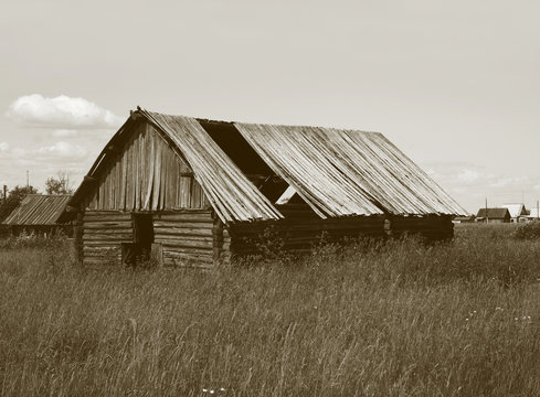 Old wooden shed with broken roof