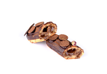 Delicious dessert on a white background. A fresh and tasty eclair is isolated on a white background, with beautiful decor.