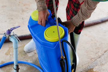agriculturist spraying pesticides fertilizers, agriculturist uses chemicals on the farm.