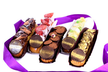 Delicious dessert on a white background. A fresh and tasty eclair is isolated on a white background, with beautiful decor.