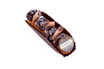 Delicious dessert on a white background. A fresh and tasty eclair is isolated on a white...