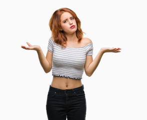 Young beautiful woman over isolated background clueless and confused expression with arms and hands...