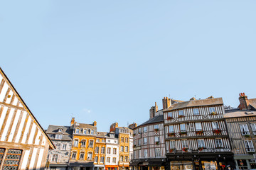 Beautiful facades of the old buildings in the central square in Honfleur, famous french town in Normandy. Wide angle view with copy space