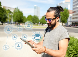 travel, car sharing and modern technology concept - man traveling tablet pc computer in city searching location