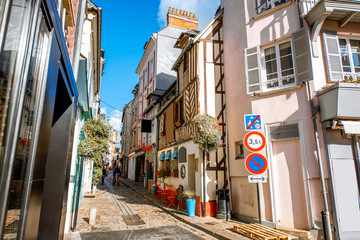 Street view with beautiful old buildings in Honfleur, famous french town in Normandy