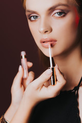 Obraz premium Lips. Skin care. Pomade. Portrait. Stylish makeup. Рortrait of beautiful young woman with clean and fresh skin. Nude makeup. Concept for cosmetology ads with copy space, beauty magazine and spa.