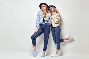 Obraz premium Two Girls Fooling Around. Fashion Autumn Outfit