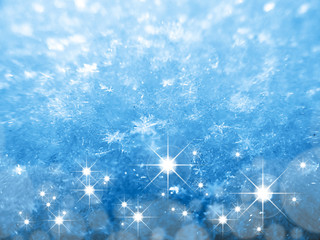 Blue Snow Texture with Snowflakes and Stars close-up. Beautiful winter and Christmas background.