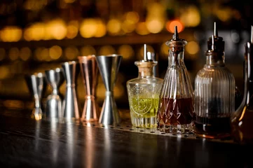 Plexiglas keuken achterwand Bar Set of professional barman tools including jiggers and little bottles with liquor