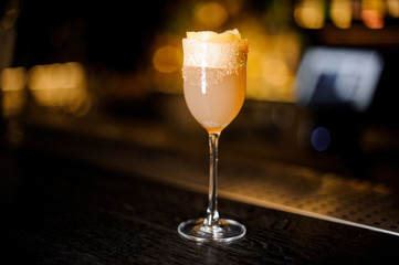 Elegant sweet wine glass filled with delicious brandy crusta cocktail on the bar counter