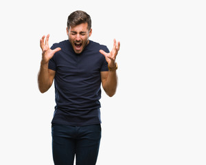 Fototapeta premium Young handsome man over isolated background celebrating mad and crazy for success with arms raised and closed eyes screaming excited. Winner concept