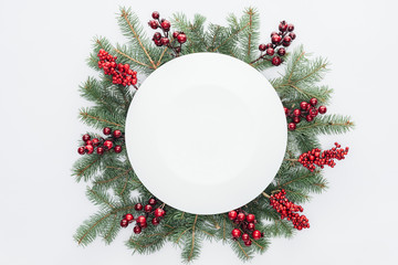 top view of pine tree wreath with Christmas decorations and round blank space in middle isolated on...