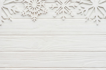 flat lay with decorative snowflakes on white wooden tabletop