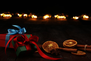 Fragrant star anise and cinnamon on wooden table and christmas gifts. xmas gift concept.