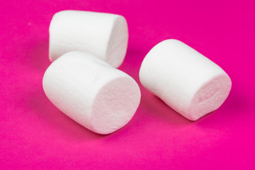 marshmallows on a pink background. top view
