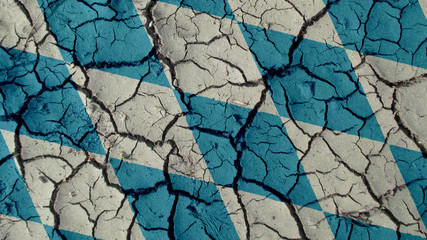 Political Crisis Or Environmental Concept: Mud Cracks With Bavaria Flag
