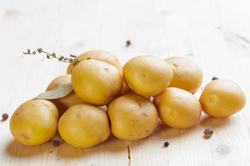 Fresh potatoes on the wood background