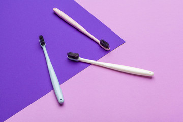 Flat lay composition with manual toothbrushes on color background, close up