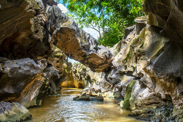 Fototapeta premium Inside view of a cave entrance stone walls.