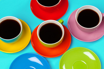 Colorful coffee cups and saucers on colorful vibrant background