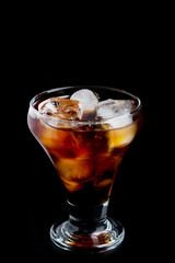 cold glass with whiskey on a black background